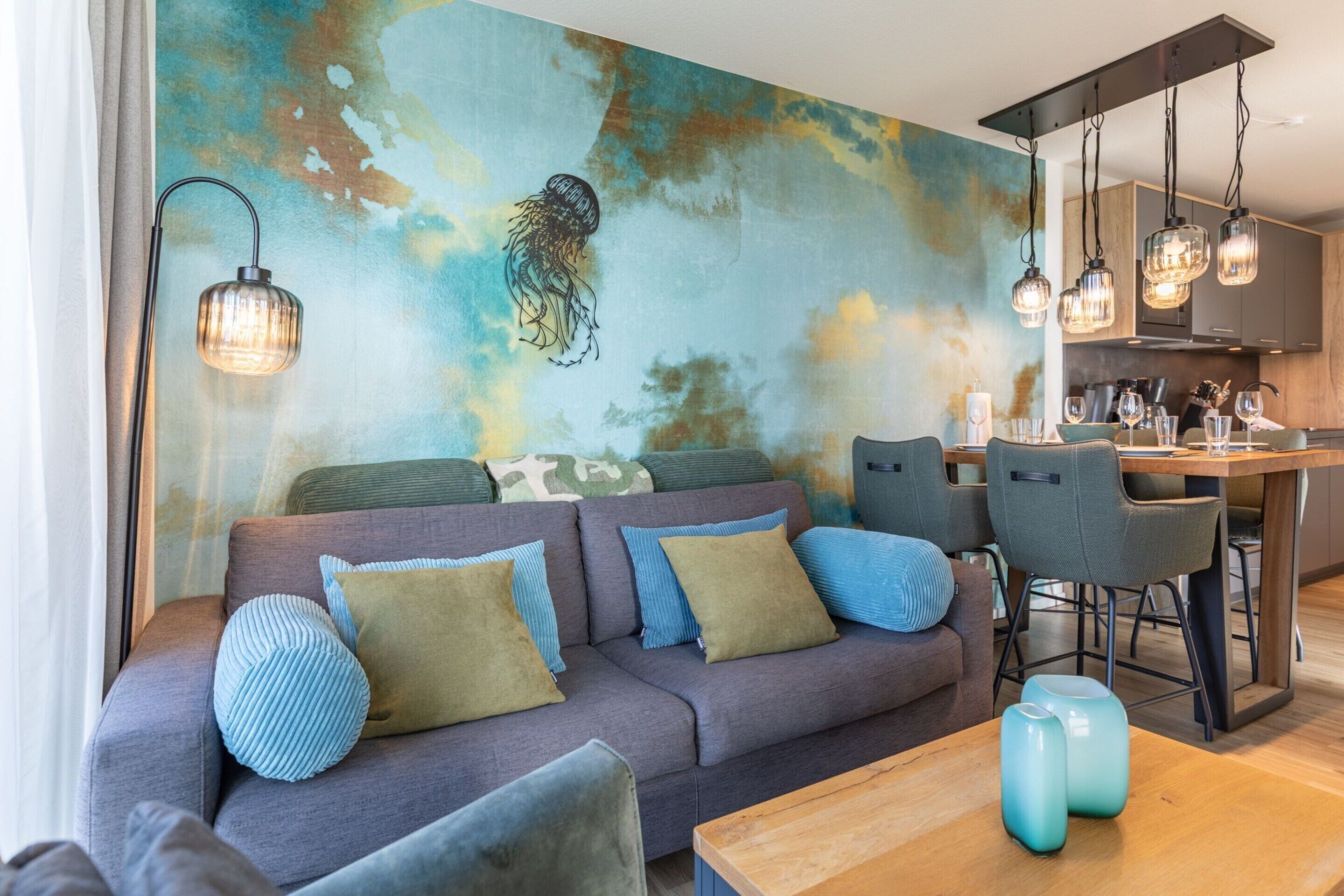 A modern living room with a sofa, chairs, and a dining area.