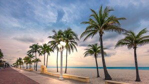 A beach promenade with palm trees, benches, and street lamps. - Direct Ocean Views + Rooftop Pool. Bar. Tennis. (Hollywood)