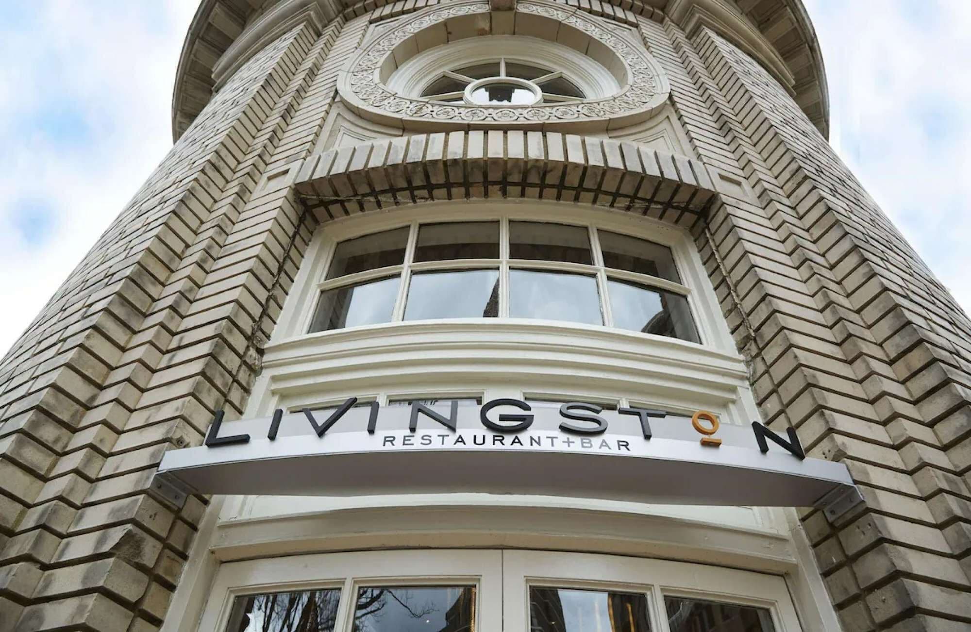 A building with a sign that reads "LIVINGSTON RESTAURANT+BAR".