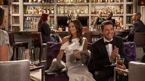 A bar area with multiple seating options, a well-stocked liquor shelf, and a bar counter. - Midtown Atlanta Stay with Skyline Views | Dining (Atlanta)