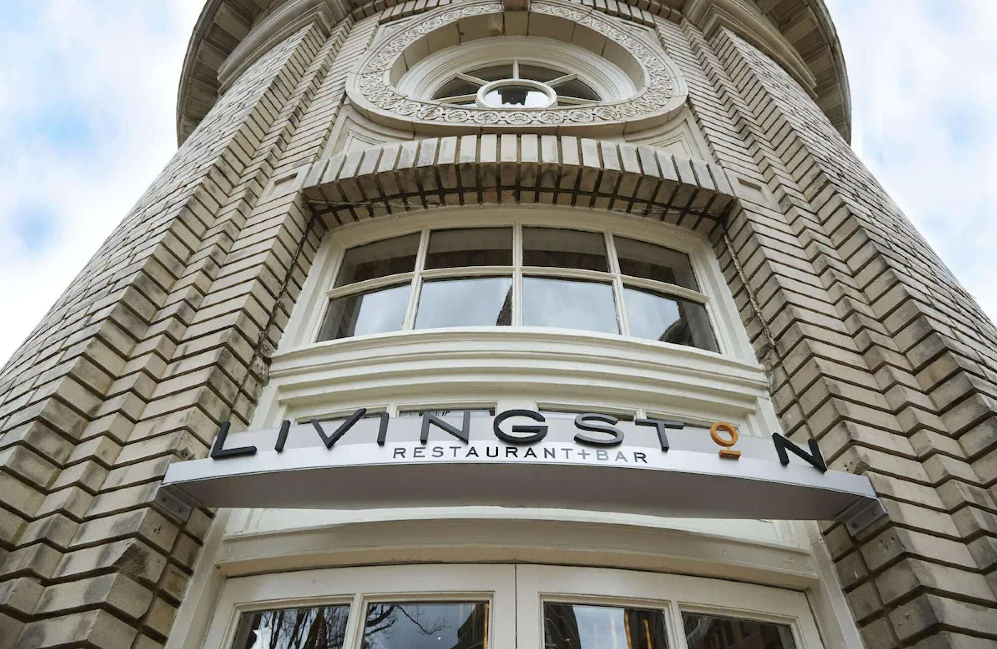 A building with a sign that reads "LIVINGSTON RESTAURANT+BAR".