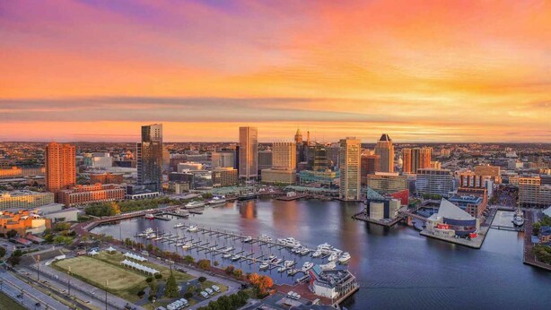 A cityscape with a marina filled with boats, surrounded by high-rise buildings. - Close to Maryland Zoo in Baltimore + Dining & Gym (Pikesville)