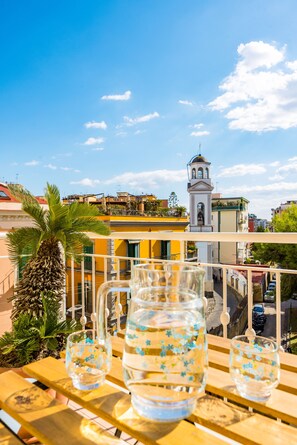 Un balcón con vistas a una torre y edificios.