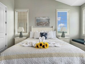 A neatly arranged bedroom with a bed, two bedside tables, a painting, and a window with blinds. - L-7 Close to SDC, lakeview clean and cozy (Branson)