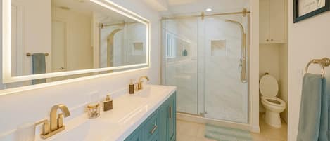 Shower, hair dryer, towels, shampoo