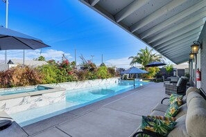 A swimming pool with a tiled deck, outdoor furniture, and umbrellas. - 7 Mi to Fremont St: Vegas Home w/ Backyard Oasis! (North Las Vegas)