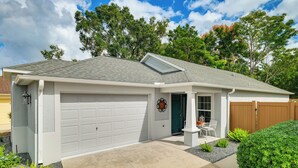 A single-story house with a garage, a covered porch, and a well-maintained lawn. - Quiet Escape in The Villages! House w/ Lanai (Wildwood)