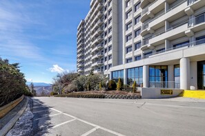 A modern high-rise building with multiple balconies and large windows. - Fun w/ Family! Sugartop Gem w/ Pool + Mtn Views (Banner Elk)