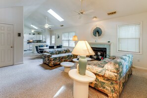 A spacious living room with a sofa, chairs, a coffee table, and a fireplace. - 2 Mi to Bethany Beach! Family Getaway w/ Deck (Ocean View)