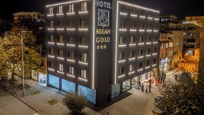 A hotel with a modern facade, multiple windows, and a prominent sign indicating it is the Aslan Gold Hotel. - Aslan Gold Hotel (Varna)