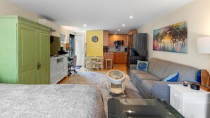 A compact living space with a kitchenette, a dining area, and a sofa. - Old Town Studio Cottage with Full Kitchen, In-Unit Laundry & Shared Pool (Key West)