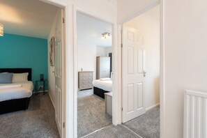 A bedroom with a bed, bedside table, and a dresser. - Toast Stays - The Garnet Rest (Brandon)
