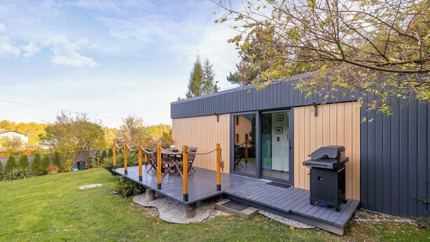 A modern house with a deck, outdoor seating, and a barbecue grill. - Modern House | Garden | Air Conditioning | Close to the Forest (Bielsko-Biała)