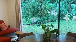 A dining area with a round table, four chairs, and a potted plant. - "bosquelago" Houserental (Tronadora)