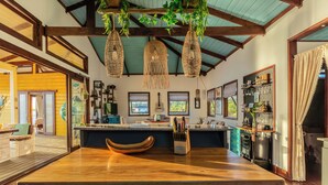 A kitchen with a wooden countertop, hanging plants, and a built-in wine rack. - Feel right at home in paradise in the eco friendly, off-grid home on Isla Colon. (Isla Colon)