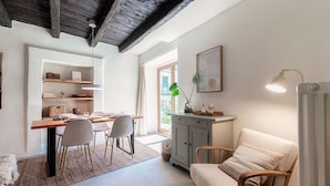 A dining area with a table, chairs, a cabinet, and a sofa. - Casa Mina - MyHomeinComo (Menaggio)