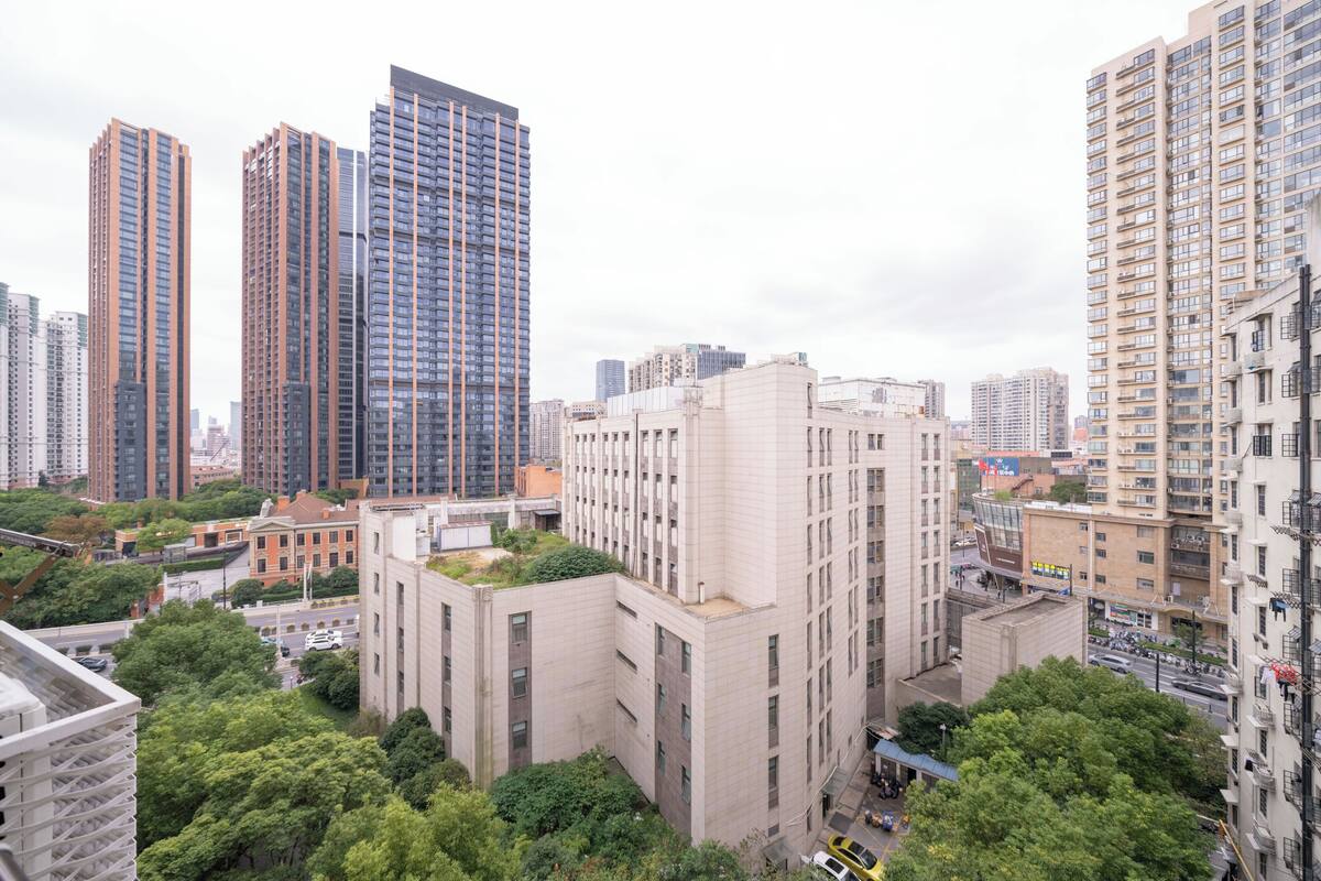 A high-rise urban area with modern buildings, including a prominent glass skyscraper.