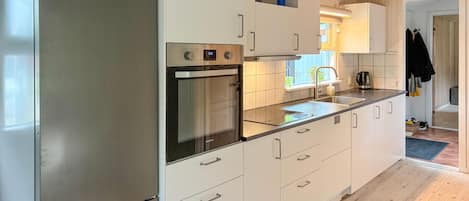 Fridge, stovetop, dishwasher, coffee/tea maker