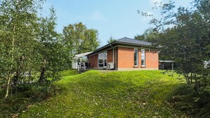 A single-story brick building with a flat roof, large windows, and a covered outdoor seating area. - 3 bedroom stunning home in Tarm (Tarm)