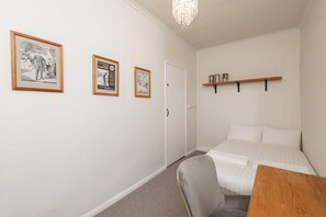 A bedroom with a bed, a chair, a desk, and three framed pictures on the wall. - Toast Stays · River-Twine (Croxdale)