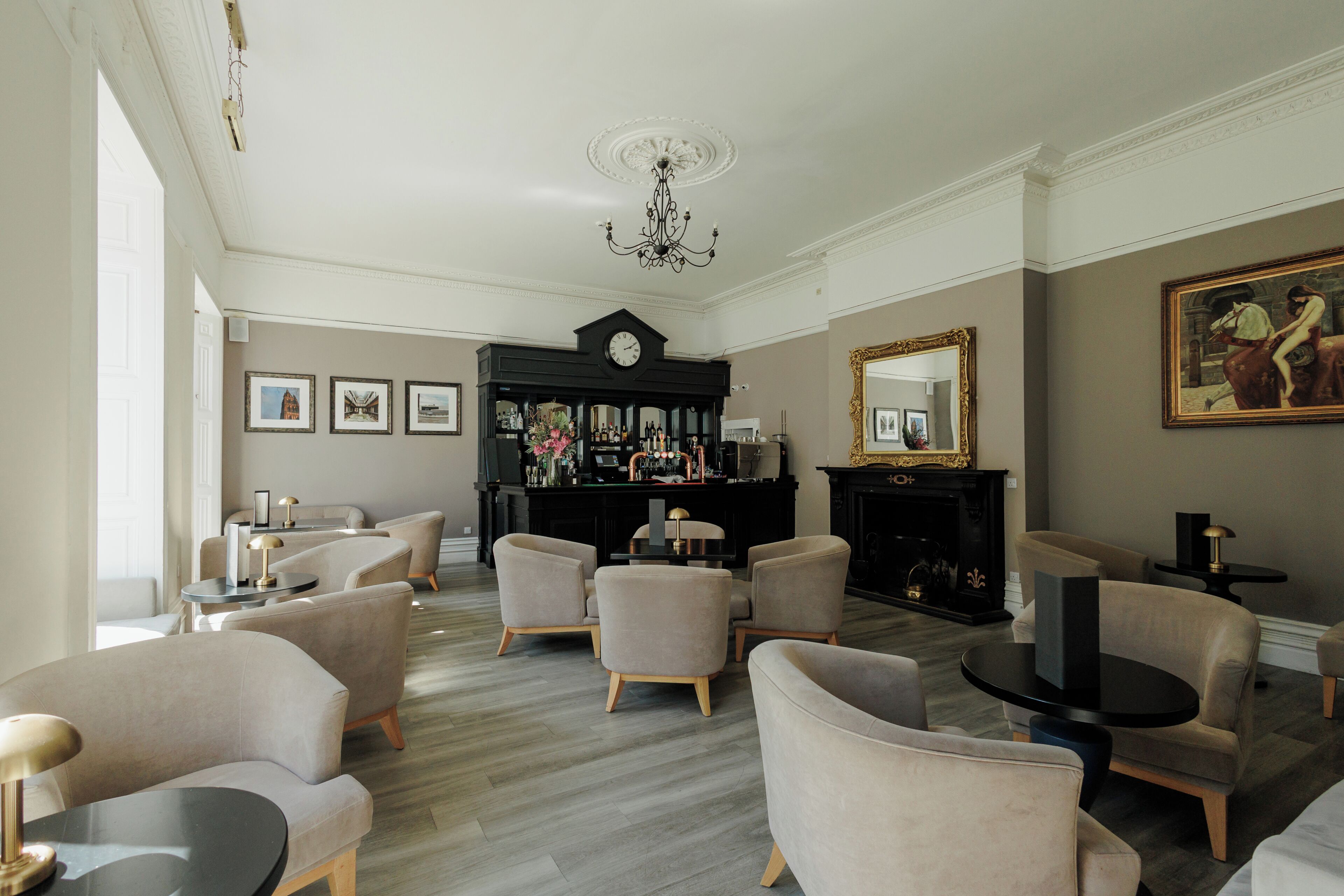 A spacious living room with a fireplace, a bar area, and a large mirror.