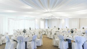 A banquet hall with round tables, white drapery, and chairs with white sashes. - Brandon Hall Hotel and Spa (Coventry)