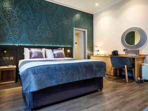 A bedroom with a bed, a desk, a chair, and a mirror. - Brandon Hall Hotel and Spa (Coventry)