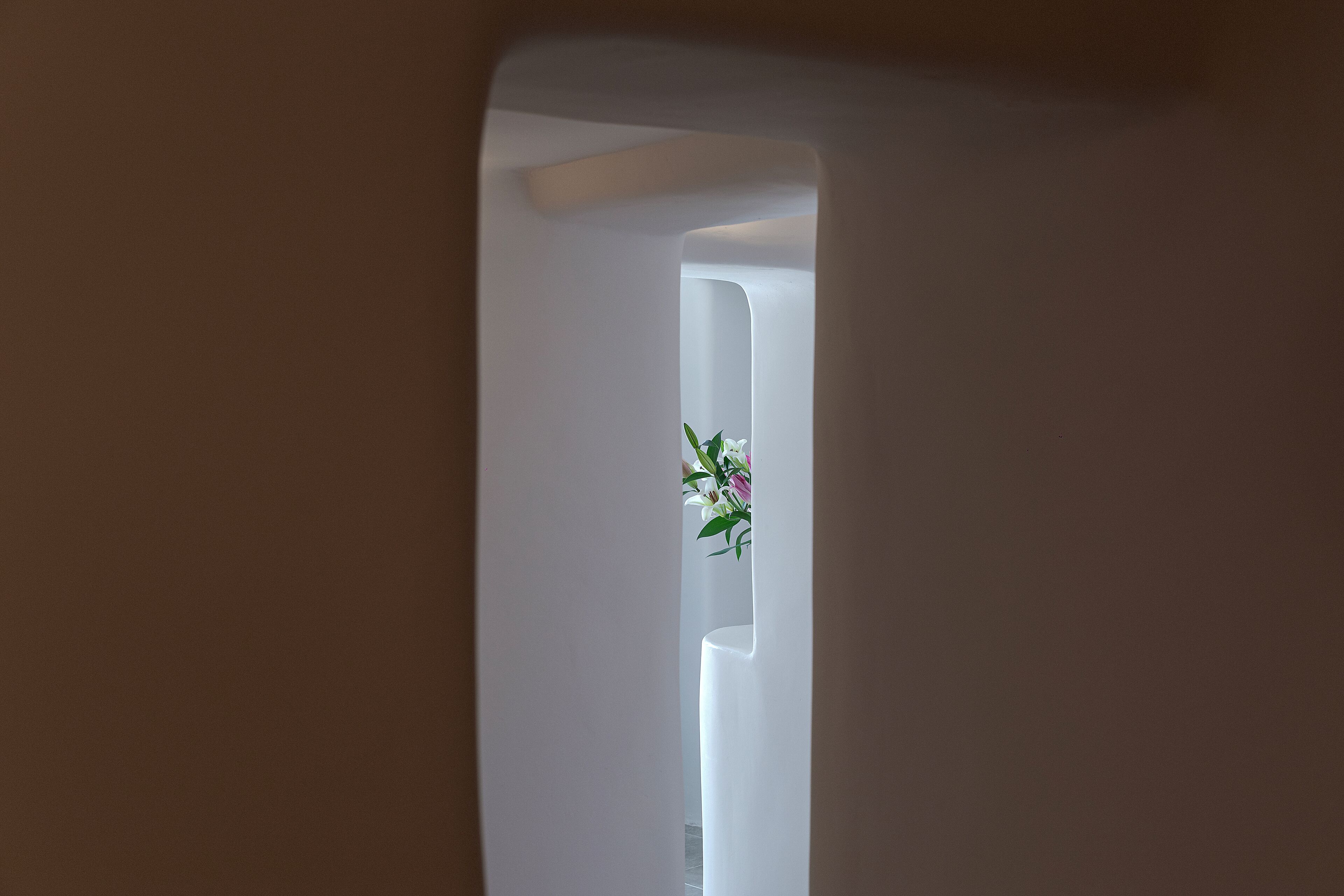A narrow hallway with a white door at the end.
