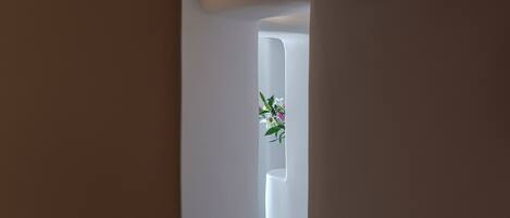 A narrow hallway with a white door at the end.