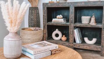 A wooden table with a vase, books, and decorative items.