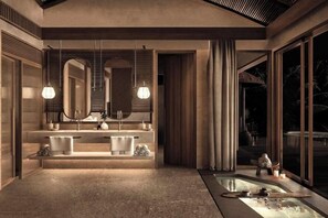 A modern bathroom with a large mirror, dual sinks, and a bathtub. - Namia River Retreat - Wellness Inclusive Resort (Hoi An)