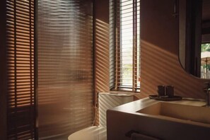 A bathroom with a modern design, featuring a large sink and a mirror. - Namia River Retreat - Wellness Inclusive Resort (Hoi An)