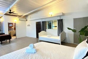 A hotel room with a bed, a desk, a chair, a ceiling fan, and a window with curtains. - Seahome Boutique Hotel (Tanjung Bungah)