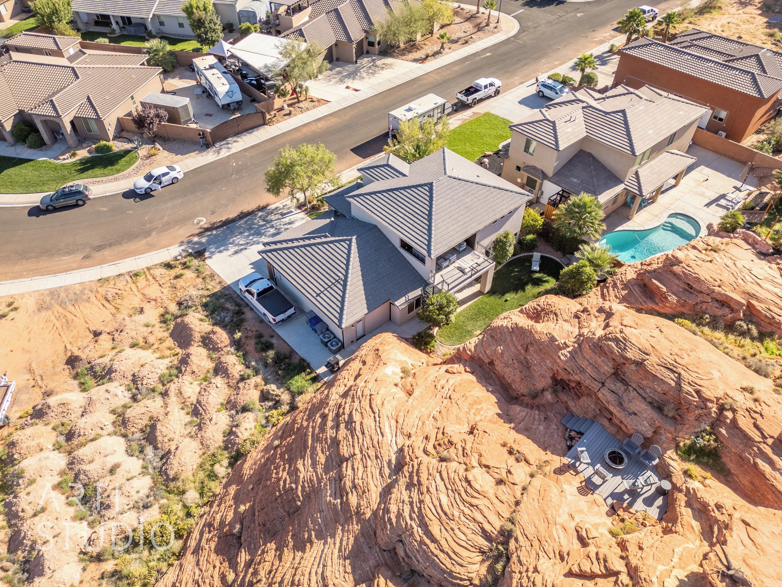 A residential area with houses, a road, and a swimming pool.