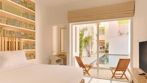 A hotel room with a bed, a desk, a TV, and a balcony with chairs. - Hotel J, Unawatuna (Unawatuna)