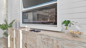 A modern kitchen with a large window, wooden cabinetry, and a decorative glass bowl on the counter. - Lux 6BR - Heated Pool | Sleeps 22 | 1 min to beach (Gulf Shores)