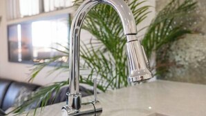 A modern kitchen with a stainless steel faucet, a countertop, and a sink. - Boardwalk Bliss Explore the Lively Mindarie Marina (Mindarie)