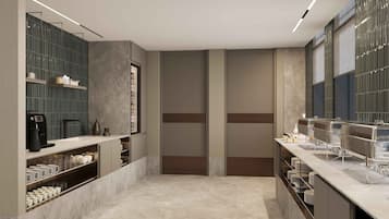 A modern kitchen with built-in appliances, a coffee machine, and a large window.