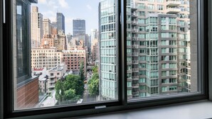 A view from a high-rise building with multiple floors, featuring a mix of modern and older architectural styles. - Fully Furnished 1BR in Murray Hills (New York)