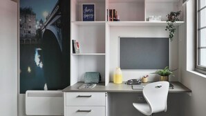 A modern study room with a large window, a white desk, a white chair, and a bookshelf. - Student Only Samuel Tuke (York)