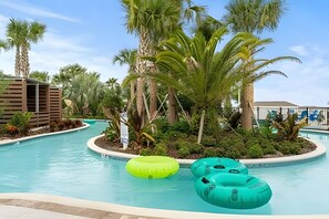 A swimming pool with inflatable rings, surrounded by palm trees and a wooden structure. - Luxury 5BR Villa at Windsor Island Resort (Davenport)