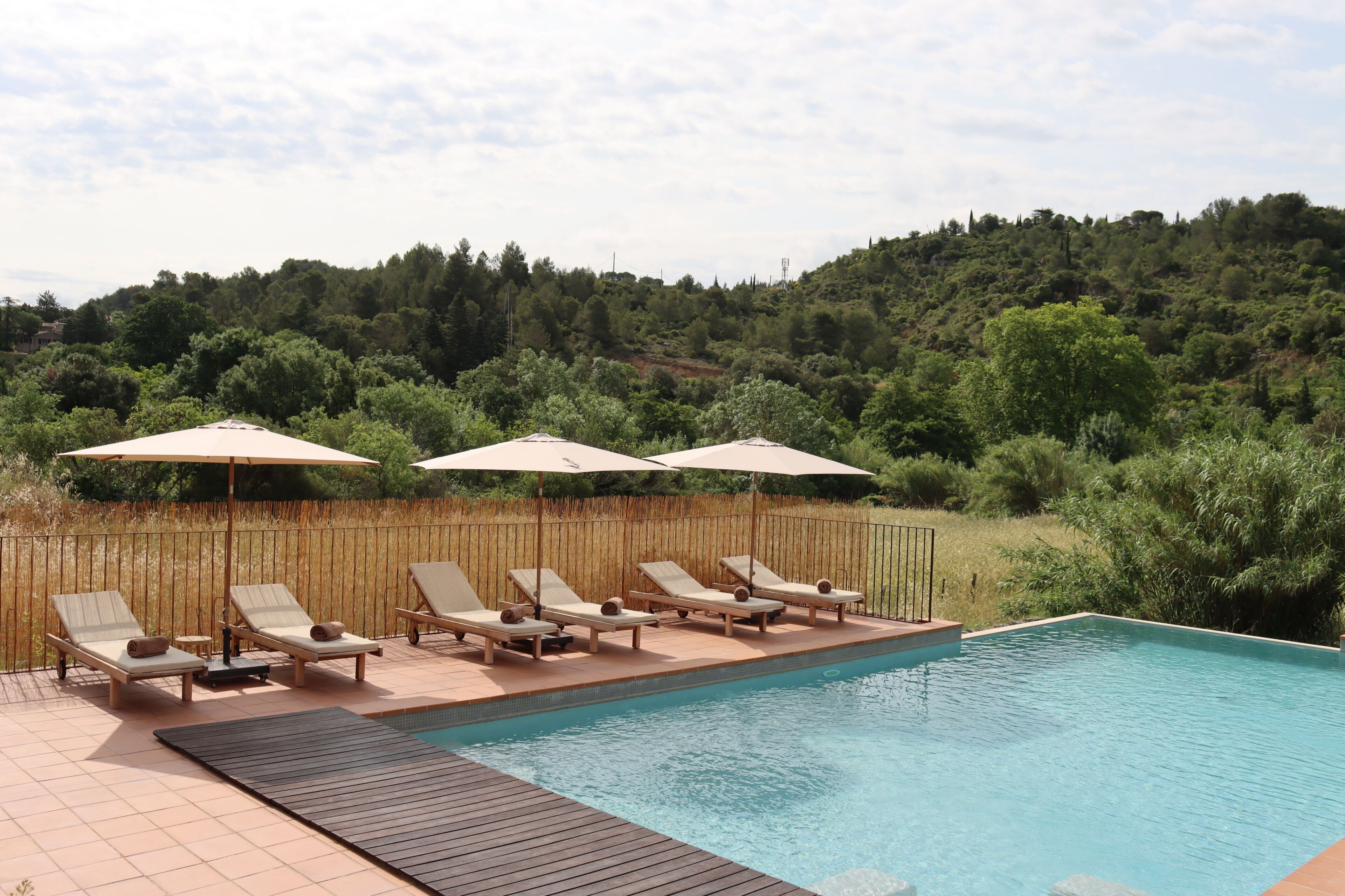 Seasonal outdoor pool, open 9:00 AM to 10:00 PM, pool umbrellas
