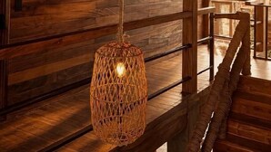 A wicker hanging light fixture in a wooden interior space. - Casona Tunan (Mizata)