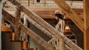 A rustic wooden staircase with a person ascending. - Casona Tunan (Mizata)