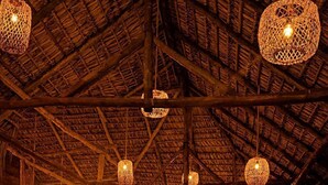 An indoor space with a high ceiling, wooden beams, and hanging woven light fixtures. - Casona Tunan (Mizata)