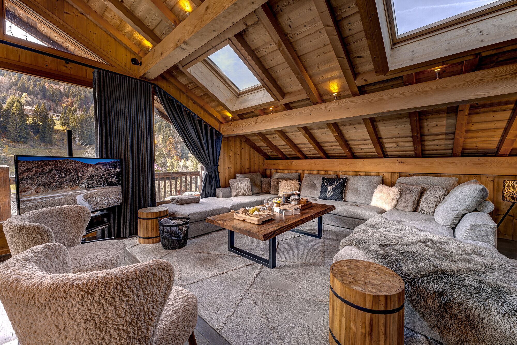 A cozy, wooden-furnished living room with a large sofa, armchairs, and a coffee table.