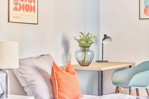 A modern room with a bed, a desk with a vase of flowers, a lamp, and a chair. - Marta - Bergheim near Cologne (Bergheim)