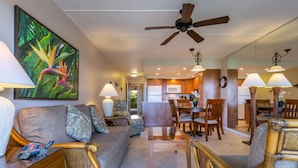 A spacious living area with a sofa, chairs, a dining table, and a ceiling fan. - Not available now (Kelowna)