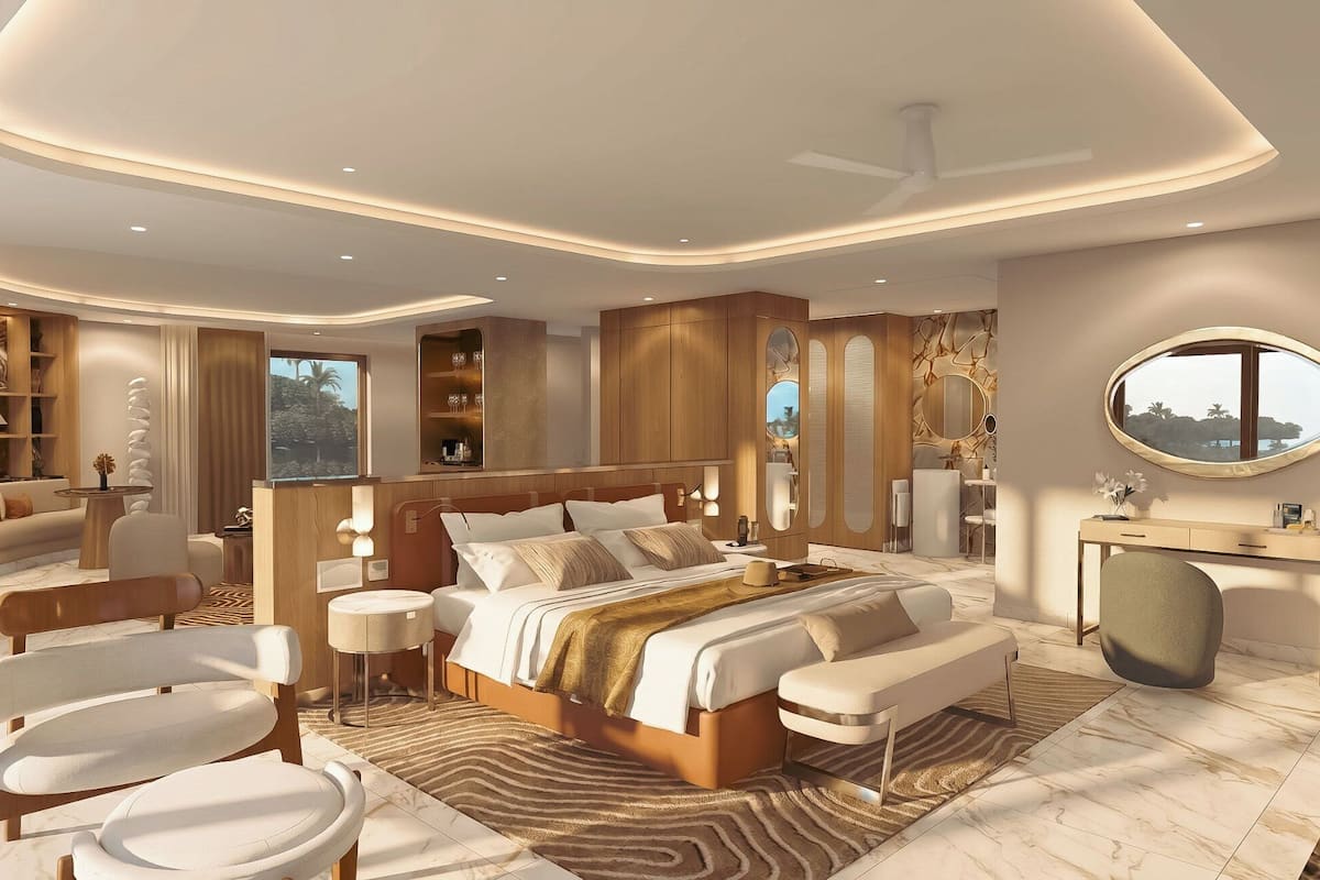 A modern bedroom with a large bed, a desk, a chair, and a vanity.