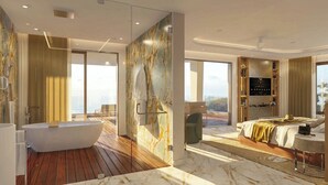 Habitación de hotel moderna con una bañera grande, una cama, zona de estar y vistas al exterior.